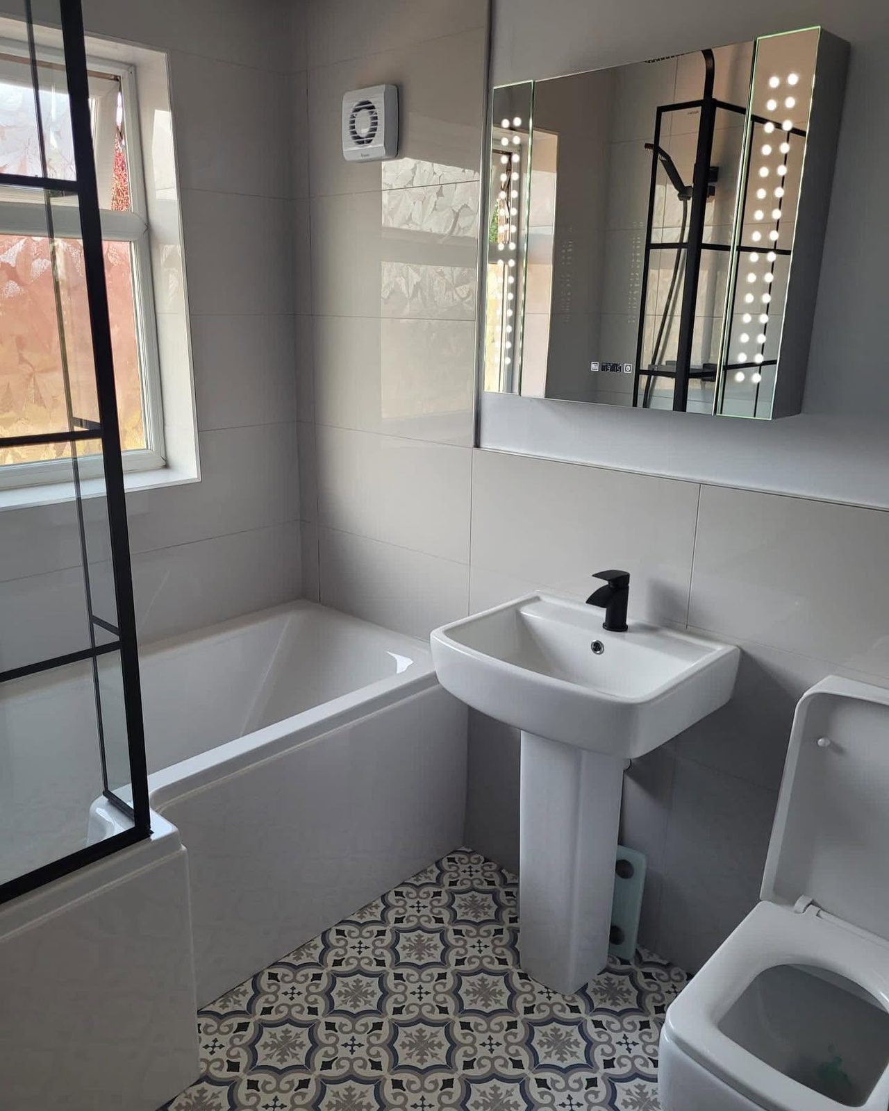 Bathroom refurbishment with ceiling spotlights and an illuminated LED mirror